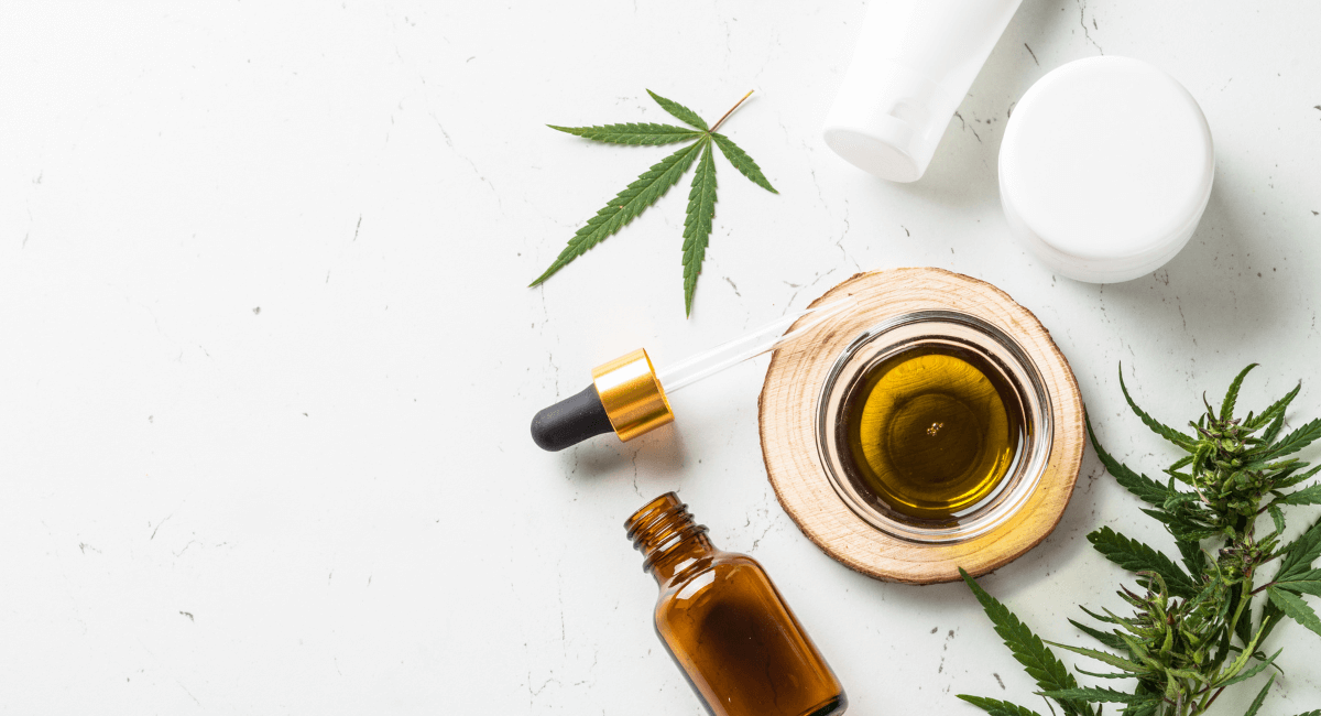 Photo layout featuring oil dropper, cannabis leaves and white background